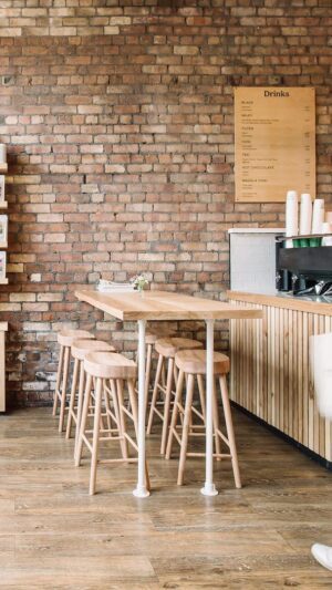 A person walking in front of a counter with stools.