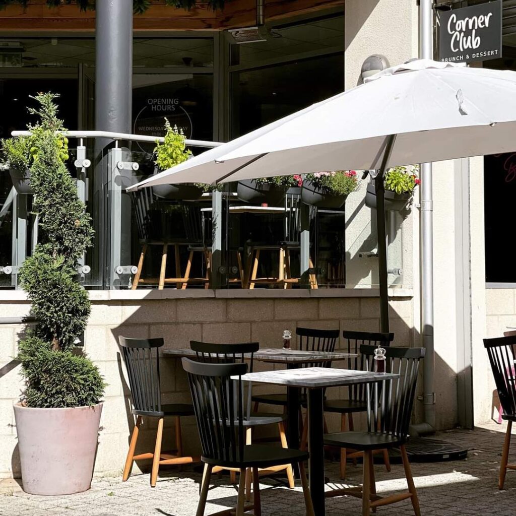 A table and chairs under an umbrella on the patio.