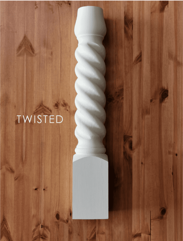 A white twisted object on top of a wooden table.